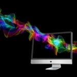 Computer with colorful abstract wavelengths moving through the screen